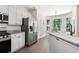 Bright eat-in kitchen features stainless steel appliances, granite countertops, white cabinets, and a breakfast nook at 2735 Princeton Trce, Cumming, GA 30041