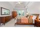 Bright bedroom featuring large windows, a bed, furniture, tray ceilings, ceiling fan, and carpeted floors at 2735 Princeton Trce, Cumming, GA 30041