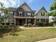 Beautiful two-story home with stone accents, manicured lawn, and charming front porch at 4316 Kershaw Dr, Snellville, GA 30039