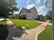 A well-maintained lawn surrounds this suburban home with a paved driveway and sidewalks at 4316 Kershaw Dr, Snellville, GA 30039