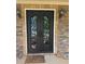 A beautiful wrought iron double door adds elegance to the stone facade of this home at 4316 Kershaw Dr, Snellville, GA 30039