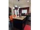 Kitchen island with dark cabinets, granite countertops, and modern pendant lighting at 4316 Kershaw Dr, Snellville, GA 30039