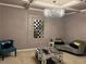 Elegant living room features a modern chandelier, sleek mirrored coffee table, and stylish decor at 4316 Kershaw Dr, Snellville, GA 30039