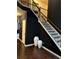 Sophisticated staircase featuring dark accents, wood floors, and neutral walls at 4316 Kershaw Dr, Snellville, GA 30039