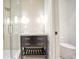 Bathroom featuring a dark vanity, glass shower, tile floor and adjacent toilet at 4550 Jolyn Pl, Sandy Springs, GA 30342