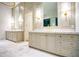 Bright bathroom featuring double vanities, marble countertops and gold hardware at 4550 Jolyn Pl, Sandy Springs, GA 30342