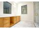 Bright bathroom with wood cabinets, marble floors, and a glass enclosed shower at 4550 Jolyn Pl, Sandy Springs, GA 30342