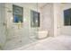 Spa bathroom featuring freestanding tub, glass shower, marble tile and gold accents at 4550 Jolyn Pl, Sandy Springs, GA 30342
