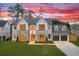Grand home with gray and white exterior, lush lawn, and 3-car garage at 4550 Jolyn Pl, Sandy Springs, GA 30342