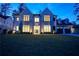 Beautiful two-story home with a stone facade, lush lawn, and 3-car garage at 4550 Jolyn Pl, Sandy Springs, GA 30342
