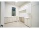 Bright kitchen with ample white cabinets, countertop space, and modern fixtures at 4550 Jolyn Pl, Sandy Springs, GA 30342