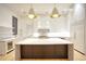 A modern eat-in kitchen features white cabinets, hardwood floors, and a center island with a marble countertop at 4550 Jolyn Pl, Sandy Springs, GA 30342