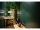 Chic powder room featuring a unique green tile wall and modern fixtures at 4550 Jolyn Pl, Sandy Springs, GA 30342