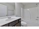 Bathroom featuring a white vanity, toilet, and a shower-tub combo with a white tile surround at 137 Staley Dr, Tucker, GA 30084