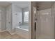Bathroom with a soaking tub, separate shower, and window for natural light at 137 Staley Dr, Tucker, GA 30084