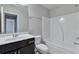 Bathroom featuring a white vanity, toilet, and a shower-tub combo with a white tile surround at 137 Staley Dr, Tucker, GA 30084