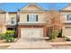 Charming townhouse featuring a brick facade and a two-car garage at 137 Staley Dr, Tucker, GA 30084