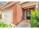 Inviting entryway with a black door, brick accents, and a well-maintained lawn at 137 Staley Dr, Tucker, GA 30084