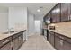 Kitchen with stainless steel appliances, granite countertops, dark wood cabinets and tiled floor at 137 Staley Dr, Tucker, GA 30084