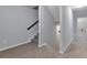 Carpeted staircase with gray walls and white trim leads to the upper level at 137 Staley Dr, Tucker, GA 30084