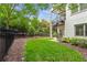 View of the backyard with a black metal privacy fence and a black spiral staircase leading to an upper floor at 210 Marjean Way, Alpharetta, GA 30009