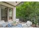 Inviting balcony with outdoor seating overlooking lush greenery, accessible from the well-appointed home office at 210 Marjean Way, Alpharetta, GA 30009