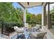 Relaxing outdoor balcony with comfortable seating and views of mature trees offering a serene retreat at 210 Marjean Way, Alpharetta, GA 30009