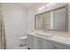 Bright bathroom with gray vanity, decorative mirror, and glass-enclosed shower with tile surround at 210 Marjean Way, Alpharetta, GA 30009