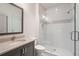 Bathroom featuring modern vanity, large framed mirror, toilet, and glass-enclosed shower with tile surround at 210 Marjean Way, Alpharetta, GA 30009