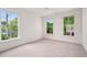 Bright bedroom with multiple windows, carpet floors, and natural light at 210 Marjean Way, Alpharetta, GA 30009