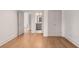 Bright bedroom with hardwood floors, featuring doorways to hall and closet, and double closets at 210 Marjean Way, Alpharetta, GA 30009