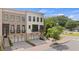 Inviting townhome showcasing brick and painted brick facade with a covered porch and attached garage at 210 Marjean Way, Alpharetta, GA 30009