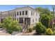 Attractive townhome exhibiting a white painted brick, covered porch, stone foundation, and a manicured lawn at 210 Marjean Way, Alpharetta, GA 30009