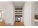 Hallway with a built-in bar area, wine fridge, and marble tile backsplash at 210 Marjean Way, Alpharetta, GA 30009