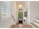 Bright hallway showcasing natural lighting and elegant staircase with wood treads at 210 Marjean Way, Alpharetta, GA 30009