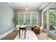 Comfortable home office with natural light, custom wallpaper, and a tranquil view of lush greenery at 210 Marjean Way, Alpharetta, GA 30009