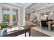 Charming home office featuring double doors leading to a balcony with a glimpse into the living space at 210 Marjean Way, Alpharetta, GA 30009