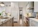 Open kitchen with stainless steel appliances, marble countertops, and hardwood flooring at 210 Marjean Way, Alpharetta, GA 30009