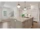 A kitchen island with marble countertops, stainless steel appliances, and pendant lighting at 210 Marjean Way, Alpharetta, GA 30009