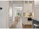 Kitchenette with stainless steel microwave, stone counters, and open access to the living area at 210 Marjean Way, Alpharetta, GA 30009
