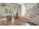 Bright living room with hardwood floors, large windows, and staircase adding architectural detail at 210 Marjean Way, Alpharetta, GA 30009