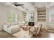 Cozy living room with fireplace, open shelving, and coffered ceilings at 210 Marjean Way, Alpharetta, GA 30009