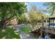 Backyard featuring a deck, brick fireplace, and mature trees at 2785 Toney Dr, Decatur, GA 30032