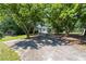 Long driveway leading to a detached garage surrounded by shade trees and greenery at 2785 Toney Dr, Decatur, GA 30032