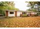 Charming single-story home with brick accents and a well-maintained front yard covered in autumn leaves at 2785 Toney Dr, Decatur, GA 30032