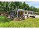Cozy backyard with a covered porch, chairs, planters, a patio, and a well-maintained lawn at 435 Mcwilliams Se Ave, Atlanta, GA 30316