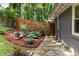 Mulched backyard features a stone walkway, shrubs, and a wooden privacy fence at 435 Mcwilliams Se Ave, Atlanta, GA 30316