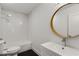 Bright bathroom with white subway tile, modern fixtures, and a round wood-trimmed mirror at 435 Mcwilliams Se Ave, Atlanta, GA 30316