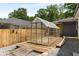 Exterior view of the greenhouse on the property with mature trees in the background at 435 Mcwilliams Se Ave, Atlanta, GA 30316