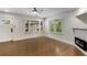 Living room featuring hardwood flooring, bright windows, and sleek electric fireplace at 435 Mcwilliams Se Ave, Atlanta, GA 30316